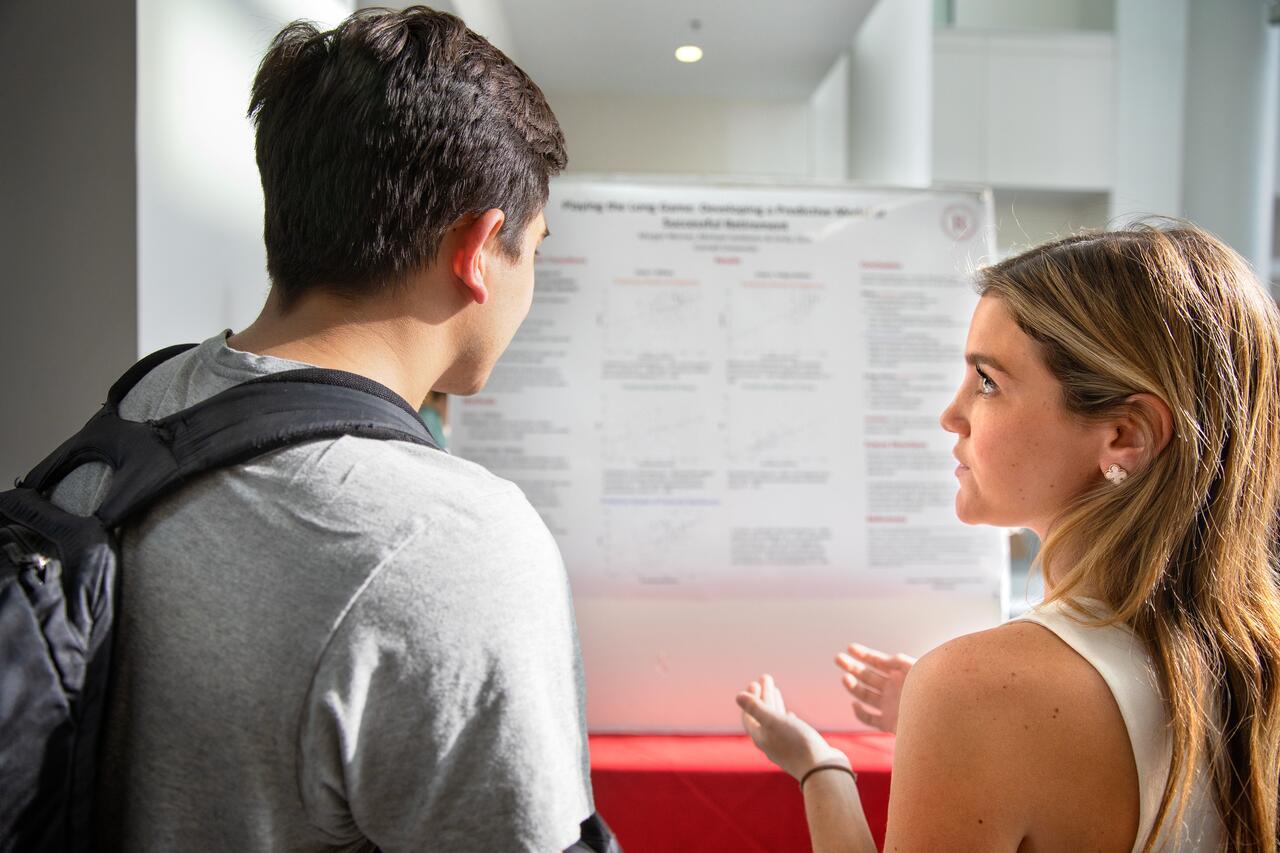 Margot Werner '19, right, presents her research at a celebration of the Rawlings Cornell Presidential Research Scholars (RCPRS) in Baker Portico in the Physical Sciences Building.
