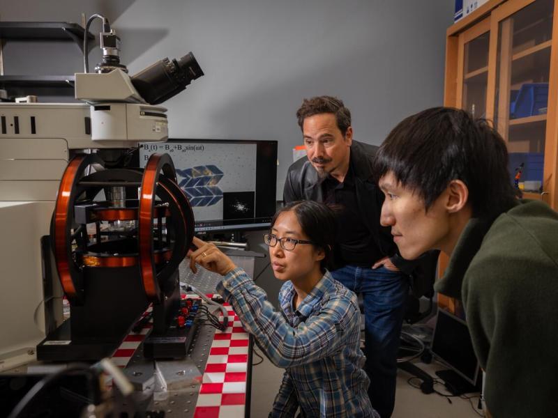 From left, Melody Lim. Itai Cohen, professor of physics and design tech, and Zexi Liang at Cohen’s lab in the Physical Sciences Building.